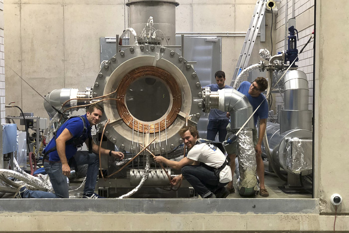 Die Crew von Synhelion mit dem Herzstück der Anlage, dem thermochemischen Reaktor.